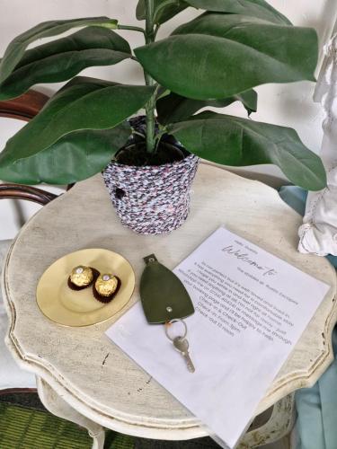 a table with a potted plant and a plate of food at charming rustic stable conversion 