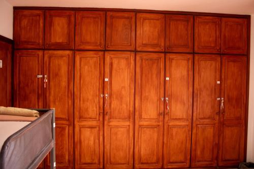a bunch of wooden cabinets in a room at Hostel Banana Surf House in Los Cristianos