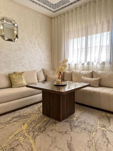 a living room with a couch and a table at Chic & Cozy Apartment for a Comfortable Stay Fes in Fès