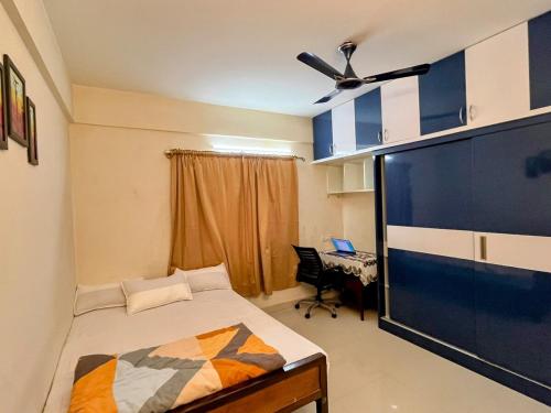 una camera con un letto e una grande TV a schermo piatto di EasyLife 2BHK Whitefield Retreat a Bangalore