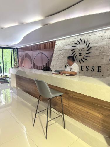 a man sitting at a counter in a restaurant at NEW Luxury Modern Condo by Menesse in Playa del Carmen