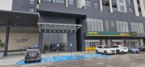 a parking lot with cars parked in front of a building at Mimpi Muji Gamuda Cove in Pulau Kempas