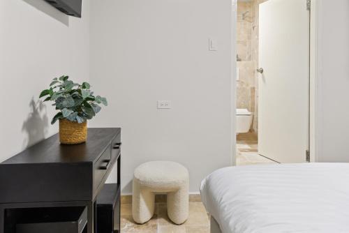 a bedroom with a bed and a desk with a chair at Caribe CBW Hotel in Willemstad