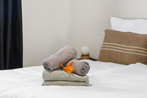 a pile of towels sitting on top of a bed at Caribe CBW Hotel in Willemstad