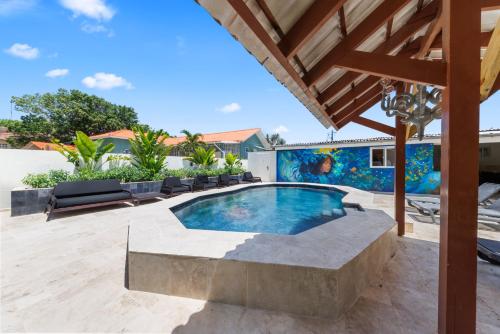 a swimming pool in the middle of a patio at Caribe CBW Hotel in Willemstad