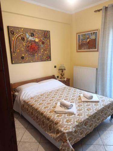 a bedroom with a bed with two towels on it at Επικούρεια Κατοικία in Gorgogýrion