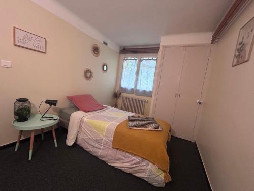 a bedroom with a bed and a chair in it at La Soleillade in Manosque