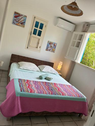 a bedroom with a bed in a room with windows at Villa Crève Cœur in Sainte-Anne