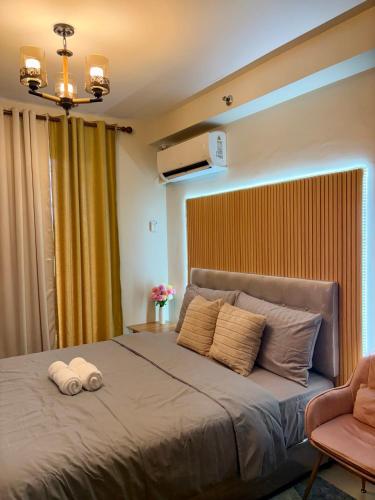 Ένα ή περισσότερα κρεβάτια σε δωμάτιο στο Alon Uno Suites - Saekyung Condominium