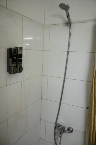 a shower with a shower head in a bathroom at Hostel Banana Surf House in Los Cristianos