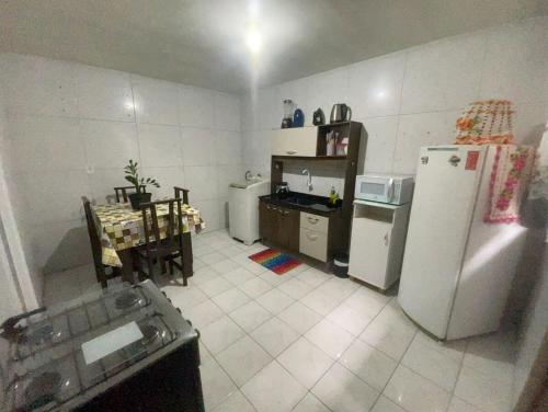 a kitchen with a refrigerator and a table in it at proximo aos principais pontos de bc in Camboriú
