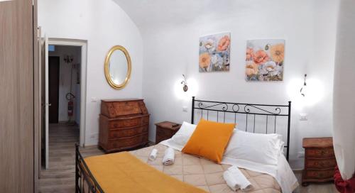 a bedroom with a bed and a mirror at Tourist rental 35574 Orvieto in Orvieto