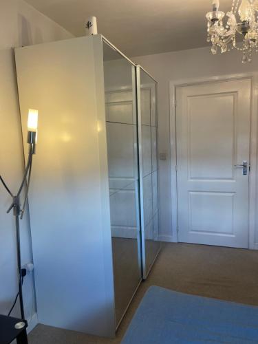 a glass elevator in a room with a door at Cozy Room in Wolverhampton City in Wolverhampton