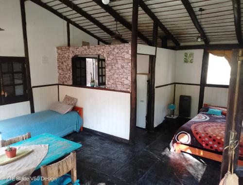 a room with two beds and a table in it at Galilea in San Miguel del Monte