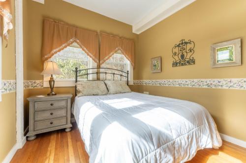 a bedroom with a bed and a window at Dominion Hill Country Inn in Bocabec
