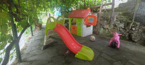 a playground with a slide and a play house at Rocca Fiorita - Bilocale con spazio esterno, parcheggio sotto casa in Baiardo