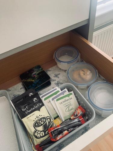 a drawer with books and other items in it at Mo-Dhachaidh B&B in Poolewe