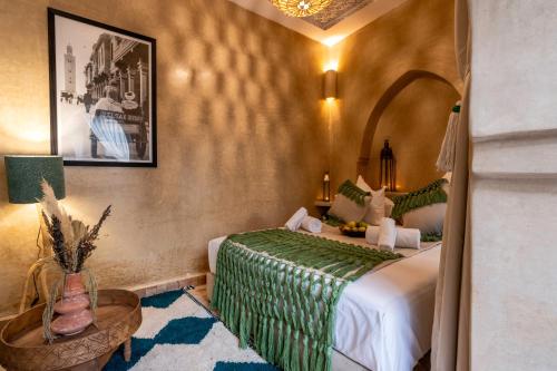 a hotel room with a bed and a table at Dar Bonita in Marrakech