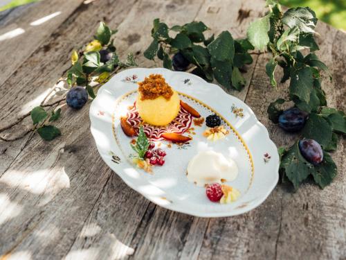 a plate of food on a wooden table at Landgasthof Hotel Linde in Stumm