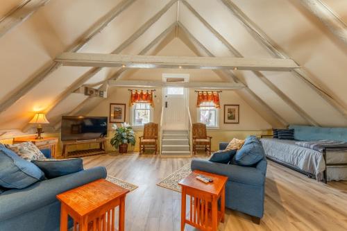 a living room with two blue couches and a tv at Dominion Hill Country Inn in Bocabec