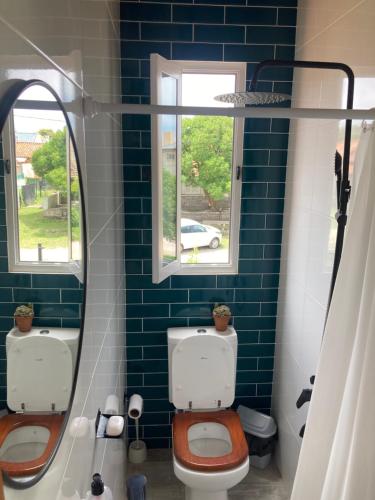 a bathroom with a toilet and a mirror at La Puertita de Acantilados in Mar del Plata