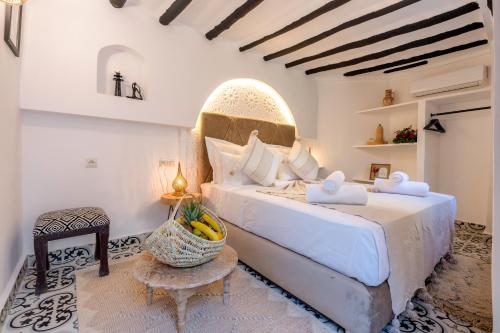 a bedroom with a large bed and a table at Dar Bonita in Marrakech
