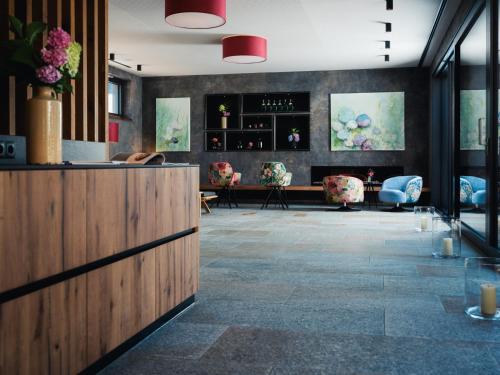 a lobby of a restaurant with a counter and chairs at Landgasthof Hotel Linde in Stumm