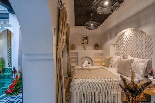 a bedroom with a bed with a white headboard at Dar Bonita in Marrakech