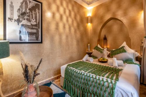 a hotel room with a bed and a picture on the wall at Dar Bonita in Marrakech