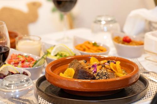a bowl of food on a table with bowls of food at Dar Bonita in Marrakech