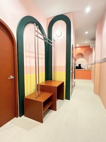 a hallway with green and pink walls and a dressing room at Babe Pool Villa Ranong in Ranong