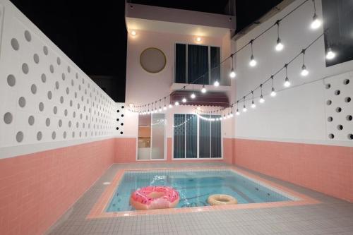 a jacuzzi tub with donuts in it at Babe Pool Villa Ranong in Ranong