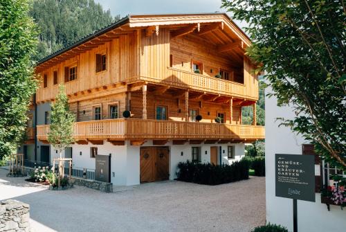 a large wooden building with a balcony on top at Landgasthof Hotel Linde in Stumm