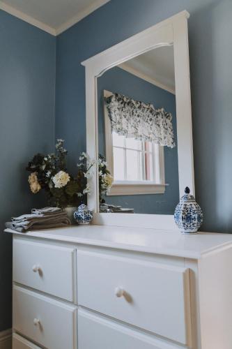 a dresser with a mirror on top of it at Dominion Hill Country Inn in Bocabec