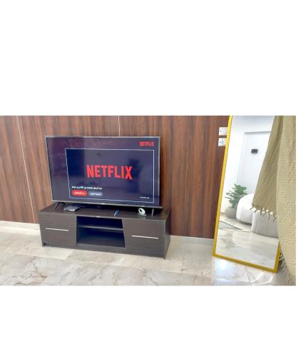 a tv sitting on a stand in a living room at Mountain View I city, 6 October, Have fun in 6th Of October