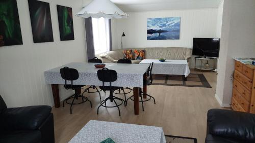 a living room with a table and chairs at Fishermens House, 3 bedrooms apartment near the sea Medby Senja in Senja