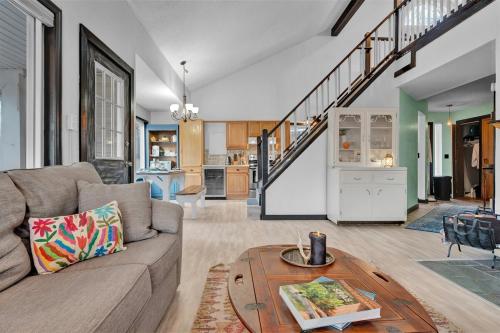 a living room with a couch and a table at Fall and Winter Forest Retreat Private Spa, Sauna & Ski in Lackawaxen