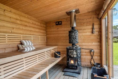 a wood burning stove in a wooden sauna at 8168-Praesto-Svalevej-7 in Præstø