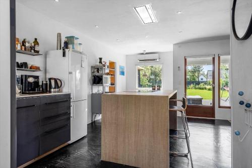 a kitchen with a white refrigerator and a counter top at 8168-Praesto-Svalevej-7 in Præstø