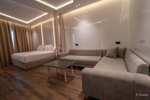 a living room with a couch and a table at Hotel Esmeralda in Chefchaouene