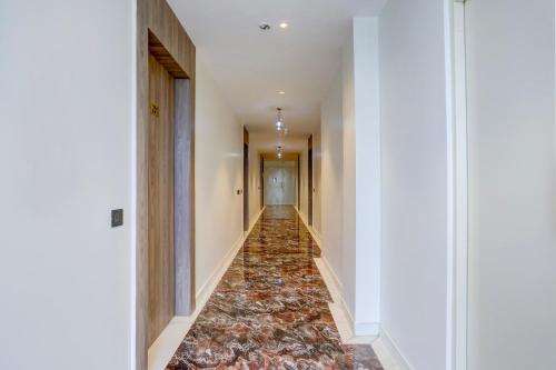 a hallway with a tile floor in a building at HOTEL O SUKUN VILLA in New Delhi