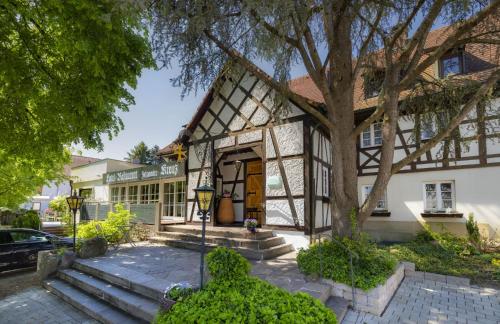 a house with a tree in front of it at Romantik Hotel Johanniter-Kreuz in Überlingen