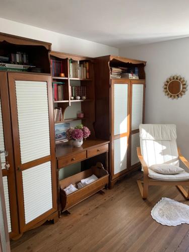a room with two windows and a desk and a chair at Bed & Breakfast Casa Marinella in Lenna