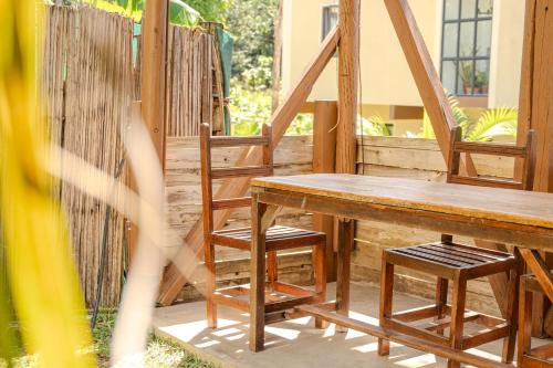 a wooden table and chairs on a porch at EvaZion in Grande Rivière Sud Est
