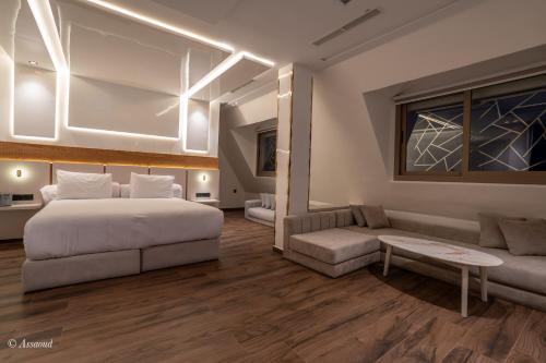 a bedroom with a bed and a couch at Hotel Esmeralda in Chefchaouene