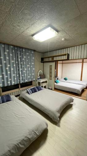 a bedroom with two beds in a room at Sound Garden Biei - Forest suite in Biei