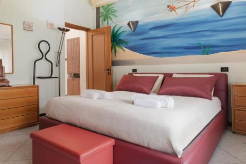 a bedroom with a large bed with red pillows at Casa dell'artista - Free Parking in Como