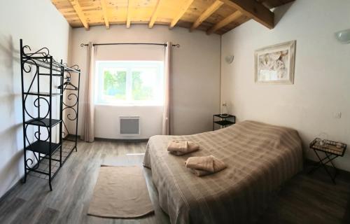 a bedroom with a bed with two pillows on it at Casa ARTEN in Alzonne
