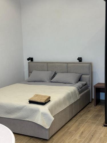 a bedroom with a bed with a wooden floor at Pysanka apartments in Kolomyya