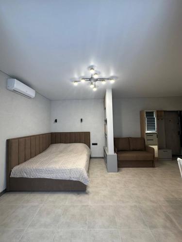 a bedroom with a bed and a ceiling fan at Pysanka apartments in Kolomyya